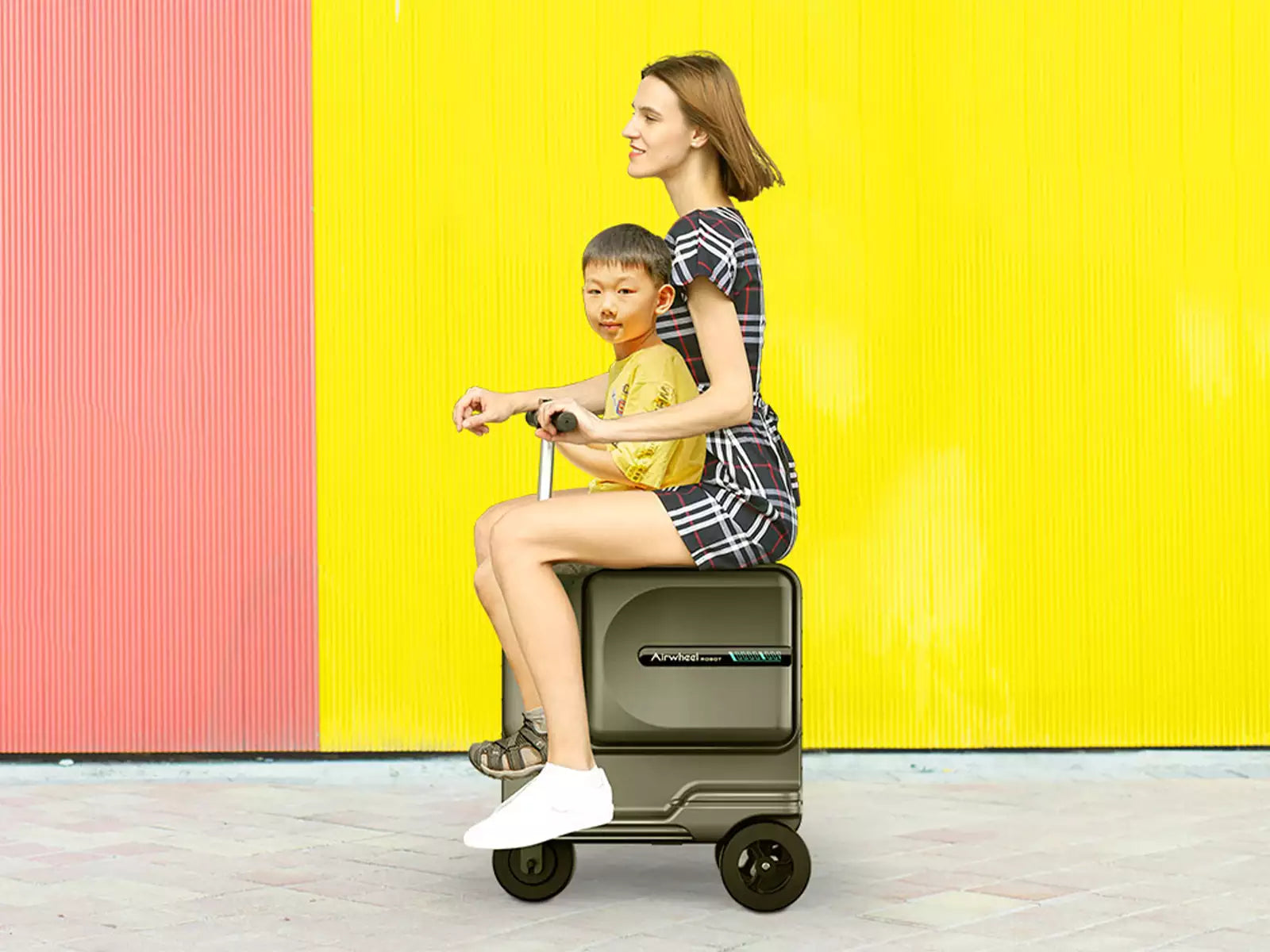 a kid and an aldult ride the Airwheel Robot SE3T